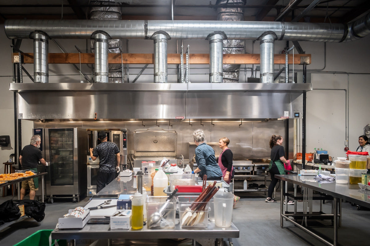The Maven Meals team at work under the hoods in the kitchen near Angle Lake in SeaTac