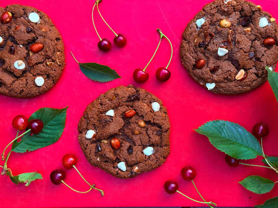 Double Chocolate Cherry Bomb cookies on a red board